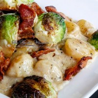 One of the best gnocchi dishes you'll ever have! Tender potato gnocchi in a bacon cream sauce, crispy bacon and roasted Brussels Sprouts.