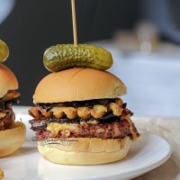 This Triple B Burger is a mixture of Beef, Bacon, AND BBQ sauce in the burger! Topped with more crispy bacon, cheese, tangy bbq sauce, caramelized onions and waffle fries - seriously, this burger is LIT!