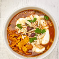 This soup features seasoned Mexican shredded chicken, beans, jalapenos, fresh herbs, smoky tomato broth, and a hint of lime making it the perfect soup on a chilly day. Chicken Tortilla Soup, best chicken tortilla soup recipe, Mexican chicken tortilla soup, easy chicken tortilla soup, classic chicken tortilla soup, white chicken tortilla soup, authentic chicken tortilla soup