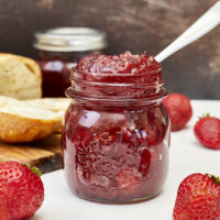 Sweet strawberries, acidic white balsamic vinegar, & spicy black pepper make this one of the most amazing jams you'll ever eat! From grazing boards to baked brie, atop grilled steak, or on a turkey sandwich, this jam will quickly become your favorite! Ultimate Strawberry Black Pepper Balsamic Jam, savory jam, homemade jam, strawberry jam with pectin, small batch strawberry jam. goat cheese jam, sandwich spread, savory jelly, pepper jelly, spicy pepper jelly, spicy pepper jam, strawberry chutney