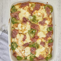 This old family recipe is the perfect comfort food any night of the week! Creamy cheesy rice topped with fork-tender boneless chops, broccoli, & crispy prosciutto. Ultimate Cheesy Smothered Pork Chops Broccoli And Rice Casserole, boneless pork chops, pork loin, cheesy rice, broccoli casserole, weeknight recipe, potluck recipe, comfort food recipes, easy dinner, meal prep recipes