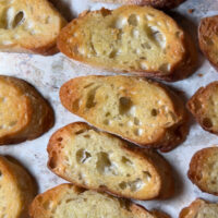 Making crostini from scratch is super easy and is so inexpensive. Stop buying premade stuff and start making it homemade! It's the perfect appetizer base and soup dipper! The Best & Easiest Homemade Crostini, appetizer toast, easy toast, french baguettes, crunchy bread, crispy bread