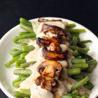 These Sophisticated green beans put an elevated twist on the classic green bean casserole. The Best homemade mushroom cream sauce drizzled over fresh green beans and caramelized mushrooms. Seriously, so incredibly delicious!