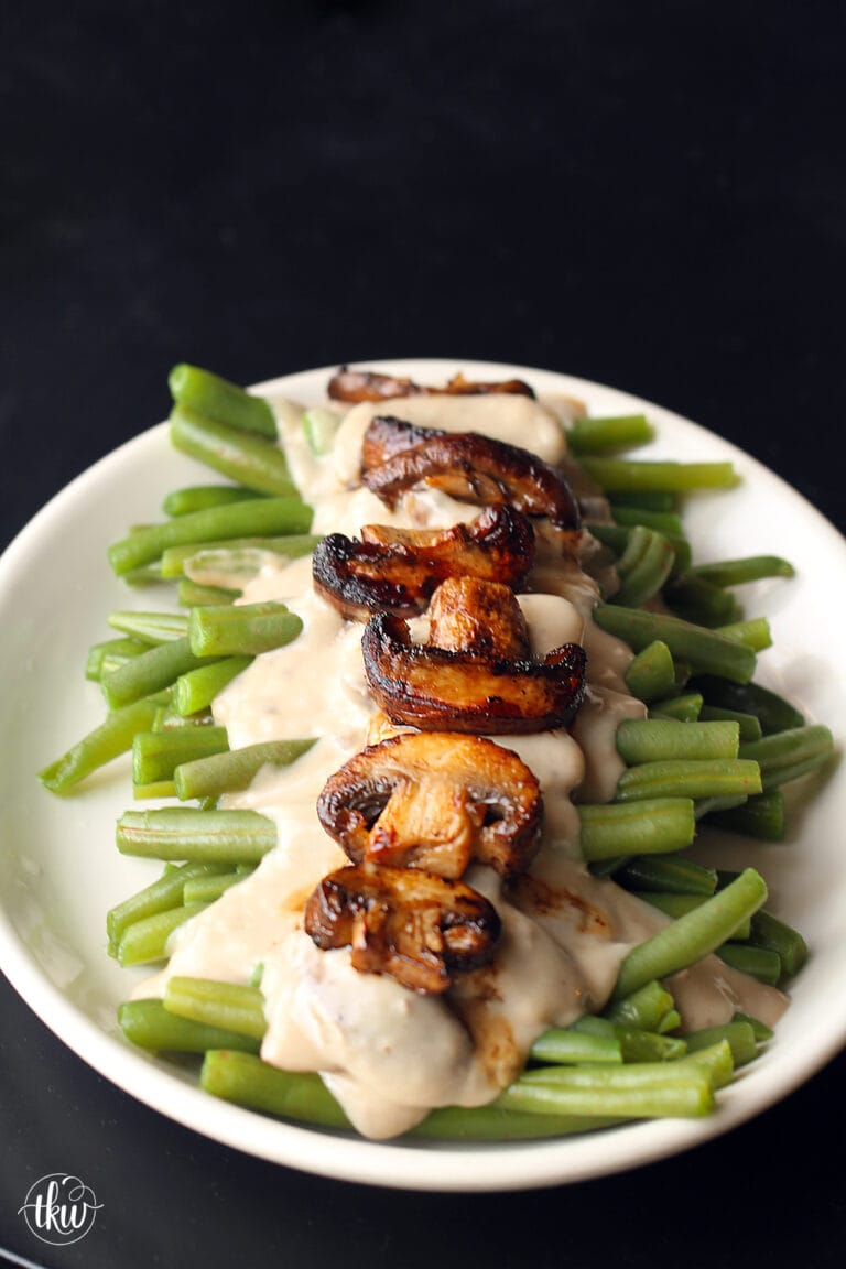 These Sophisticated green beans put an elevated twist on the classic green bean casserole. The Best homemade mushroom cream sauce drizzled over fresh green beans and caramelized mushrooms. Seriously, so incredibly delicious!