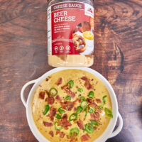 This loaded cheesy dip starts with the Hoosier Hill Beer Cheese Mix, more beer, shredded cheddar & smoked Gouda, crispy bacon, and minced jalapenos! This dip comes together in minutes! Ultimate Loaded Beer Bacon Jalapeno Cheese Dip, beer cheese, hot beer cheese dip, pretzel dip, football food, cheesy dip, beer dip