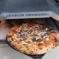 Authentic wood-fired pizzeria-style pizza made in your Yoder Smokers Pizza Oven. This is the must-have accessory for your Yoder Smoker! Don’t have a Yoder? Upgrade today! Authentic Pizzeria Style Pizza Made In The Yoder Smokers Pizza Oven, YS640 pizza oven, pellet smoker pizza, pellet grill pizza, backyard pizza, smoked pizza