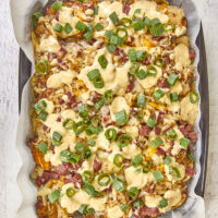 Pub-Style Irish Nachos are crispy thin potatoes topped with 3 types of cheeses, corned beef, sauerkraut, green onions and beer cheese. Ultimate Crunchy Pub Grub: Crispy Potato Sauerkraut Irish Nachos, corned beef and sauerkraut, crispy potato nachos, cheesy potatoes, baked cheesy potatoes, sauerkraut