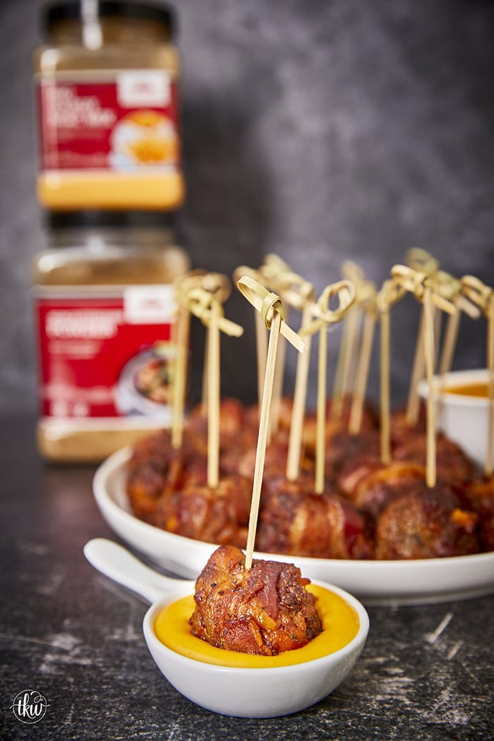 Tender, juicy meatballs oozing with cheesy goodness wrapped in seasoned bacon. It's time to fire up the smoker to make one of the best appetizers you'll ever eat! Bacon Wrapped Cheesy Big Mac Meatballs On The Smoker, cheesy meatballs, smoked meatballs, meatballs on the smoker, game day appetizers, meatballs stuffed with cheese