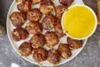 Tender, juicy meatballs oozing with cheesy goodness wrapped in seasoned bacon. It's time to fire up the smoker to make one of the best appetizers you'll ever eat! Bacon Wrapped Cheesy Big Mac Meatballs On The Smoker, cheesy meatballs, smoked meatballs, meatballs on the smoker, game day appetizers, meatballs stuffed with cheese