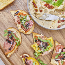 Truly a taste of Italy! Combining the richness of sundried tomatoes with the creamy goodness of whipped Italian herb ricotta, juicy heirloom tomatoes, prosciutto, basil ribbons, and a drizzle of balsamic glaze all atop crispy crostini to make the perfect Italian bite! Ultimate Heirloom Tomato Ricotta Prosciutto Italian Crostini, whipped Italian ricotta, easy summer appetizers, prosciutto crostini, no bake recipes, garden appetizers