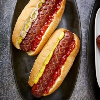 Are you looking to take your cookout game to the next level? Cross-hatching hotdogs, seasoning them with brisket seasoning, and smoking them make them one of the best hot dogs you'll ever have! The Best Smoked Hot Dogs You'll Ever Eat, cross-hatch cut hot dogs, yoder smoked hot dogs, grilled hot dogs, cook out foods, football food, game day eats