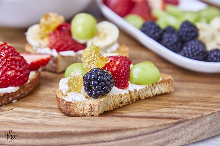 Honeycomb, whipped vanilla honey ricotta, and fresh fruits come together in a heavenly dessert crostini. This simple and sweet delight that will elevate any gathering or simply satisfy your sweet cravings. Simple Sweet Honeycomb Ricotta & Fresh Fruits Dessert Crostini, sweetened ricotta, ricotta spread, dessert ricotta, uses for leftover ricotta, bagel spread, crostini spread, cheesy dip, fruit dip, 3-ingredient ricotta dip