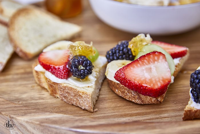 Honeycomb, whipped vanilla honey ricotta, and fresh fruits come together in a heavenly dessert crostini. This simple and sweet delight that will elevate any gathering or simply satisfy your sweet cravings. Simple Sweet Honeycomb Ricotta & Fresh Fruits Dessert Crostini, sweetened ricotta, ricotta spread, dessert ricotta, uses for leftover ricotta, bagel spread, crostini spread, cheesy dip, fruit dip, 3-ingredient ricotta dip