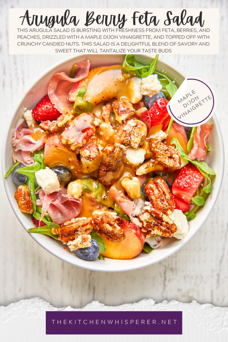 This arugula salad is bursting with freshness from feta, berries, and peaches, drizzled with a maple Dijon vinaigrette, and topped off with crunchy candied nuts. This salad is a delightful blend of savory and sweet that will tantalize your taste buds.