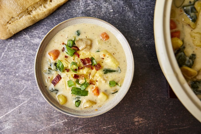 This one-pot creamy Boursin Potato Soup explodes with flavor. Finished with bacon, green onions, & cheese it's truly out of this world! Rich, velvety, and comforting, it’s the perfect dish for any occasion.