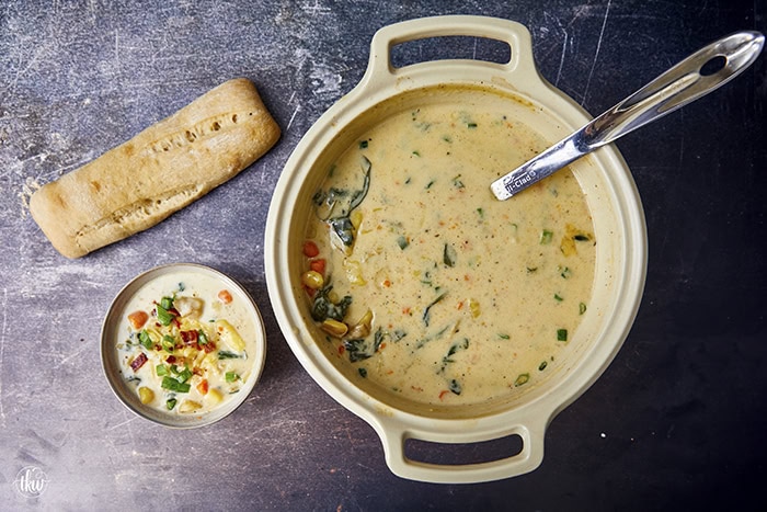 This one-pot creamy Boursin Potato Soup explodes with flavor. Finished with bacon, green onions, & cheese it's truly out of this world! Rich, velvety, and comforting, it’s the perfect dish for any occasion.