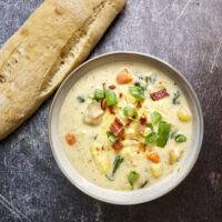 This one-pot creamy Boursin Potato Soup explodes with flavor. Finished with bacon, green onions, & cheese it's truly out of this world! Rich, velvety, and comforting, it’s the perfect dish for any occasion.