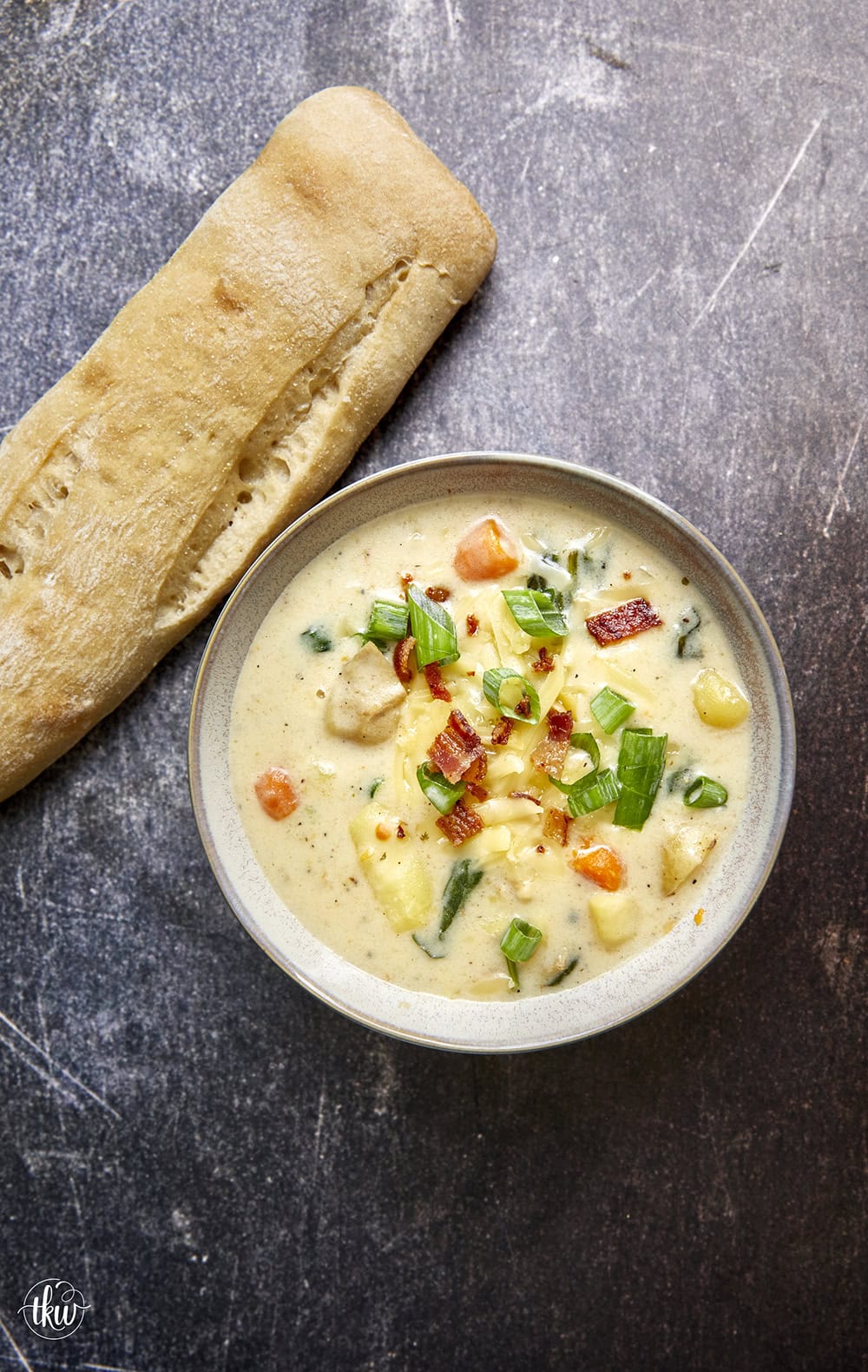 This one-pot creamy Boursin Potato Soup explodes with flavor. Finished with bacon, green onions, & cheese it's truly out of this world! Rich, velvety, and comforting, it’s the perfect dish for any occasion.