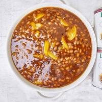 These Smoked Peach Pie Chipotle Baked Beans bring a bold, irresistible twist to a classic side dish. Slow-smoked beans soak up a rich, smoky sauce that combines the natural sweetness of peach filling with the smoky heat of chipotle peppers.