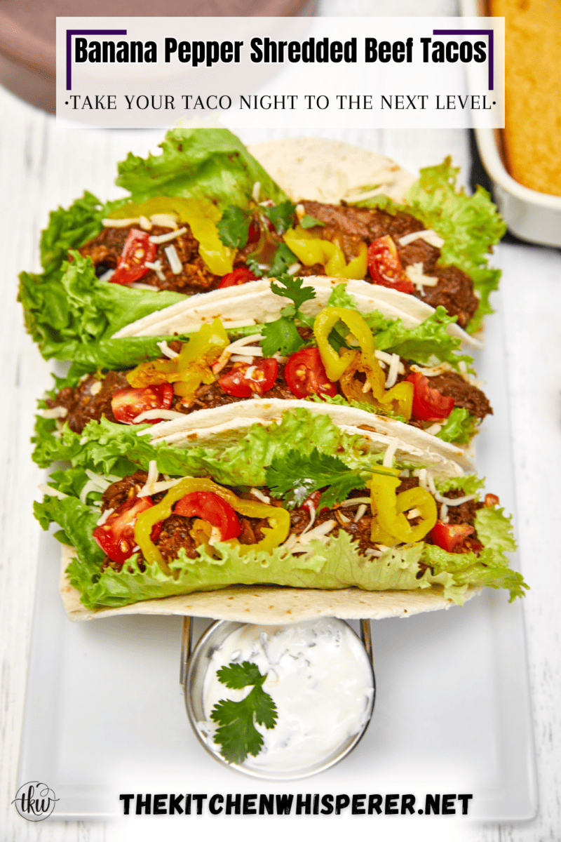 Warm flour tortillas filled with melt-in-your-mouth beef infused with bold spices, tangy banana peppers, fresh veggies, lime crema, and a sprinkling of cheese make these tacos a standout at any dinner table.