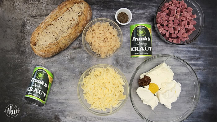 This cheesy flavor-packed recipe takes everything you love about a Guinness corned beef Reuben sandwich and bakes it into a hollowed-out Jewish rye bread loaf for the ultimate party dip.