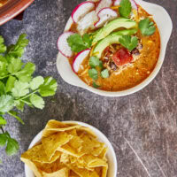 This Creamy Cheesy Chicken Enchilada Soup is the perfect blend of comfort and spice, made with simple pantry staples. Juicy shredded chicken, fire-roasted tomatoes, black beans, and peppers come together in a velvety broth infused with smoky Mexican spices. This soup delivers all the flavors of classic enchiladas in one easy, one-pot recipe.